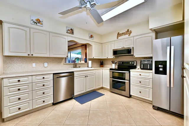 a kitchen with granite countertop cabinets and steel stainless steel appliances