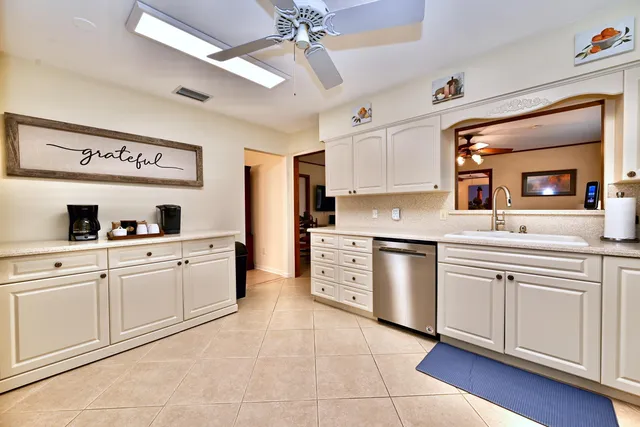 a kitchen with cabinets stainless steel appliances and a counter top space