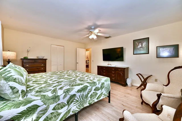 a bedroom with a bed window and a flat screen television
