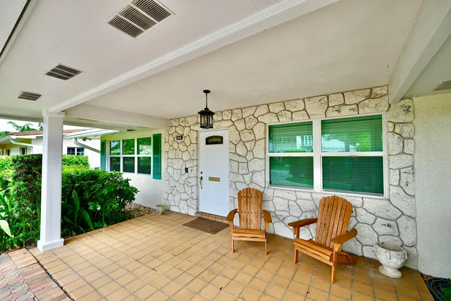 a view of a patio with table and chairs and potted plants