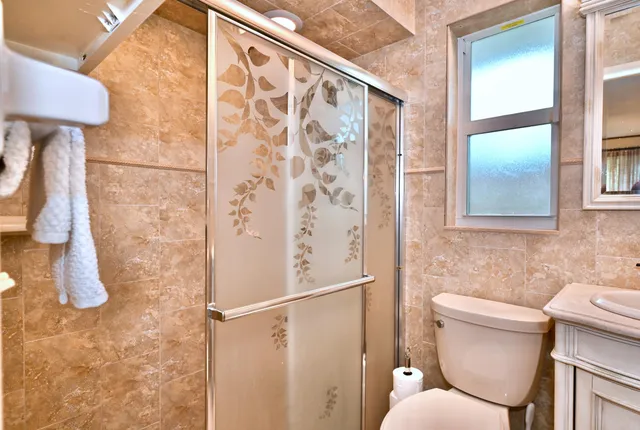 a bathroom with a toilet and a shower