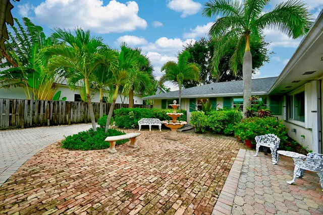 a view of a backyard with plants and a patio