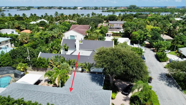 an aerial view of a house with a yard and lake view