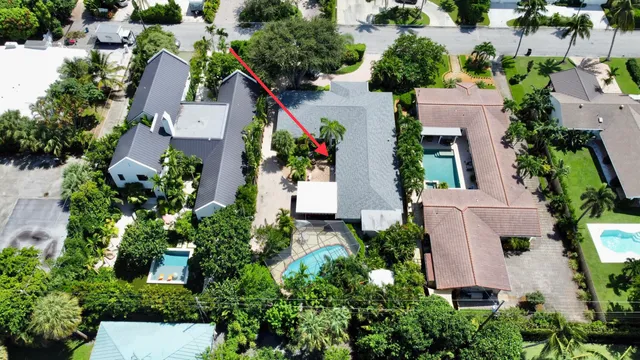 an aerial view of a house with a yard and garden