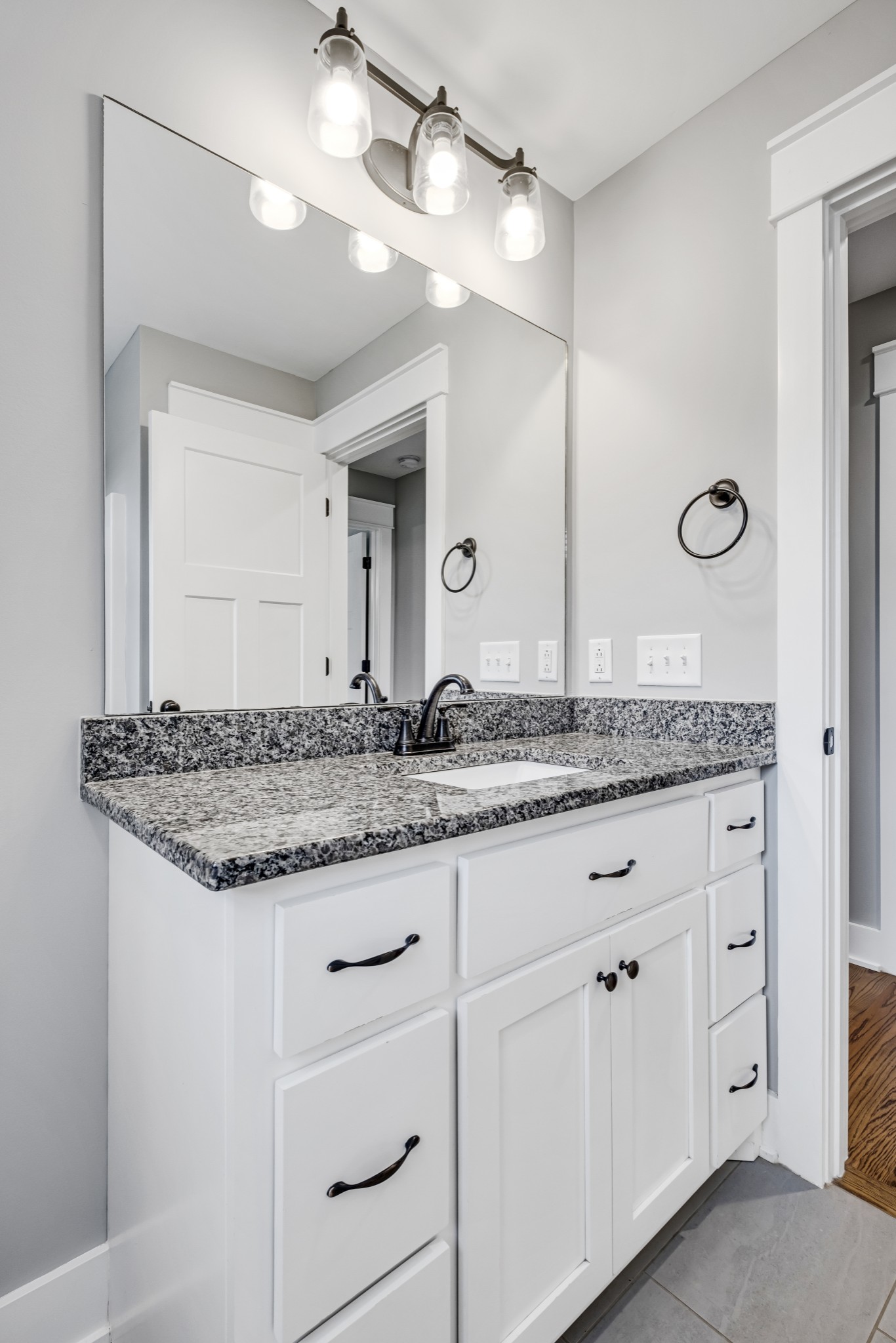 724 White Road Portland, TN 37148 - Photo 20 of 32 a bathroom with a granite countertop sink and a mirror