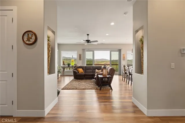 a living room with furniture fireplace and a large window