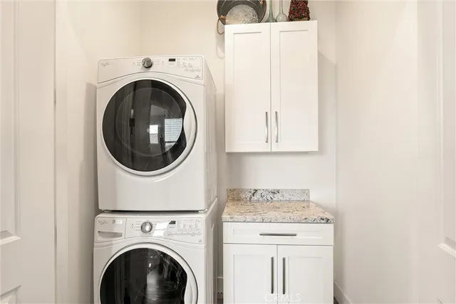 a spacious bathroom with a granite countertop sink and a mirror