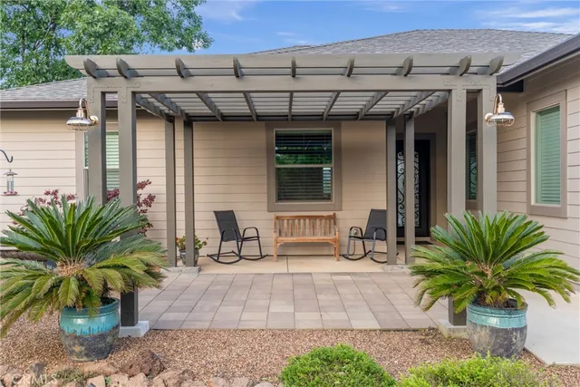 a view of a patio with potted plants and a table chair