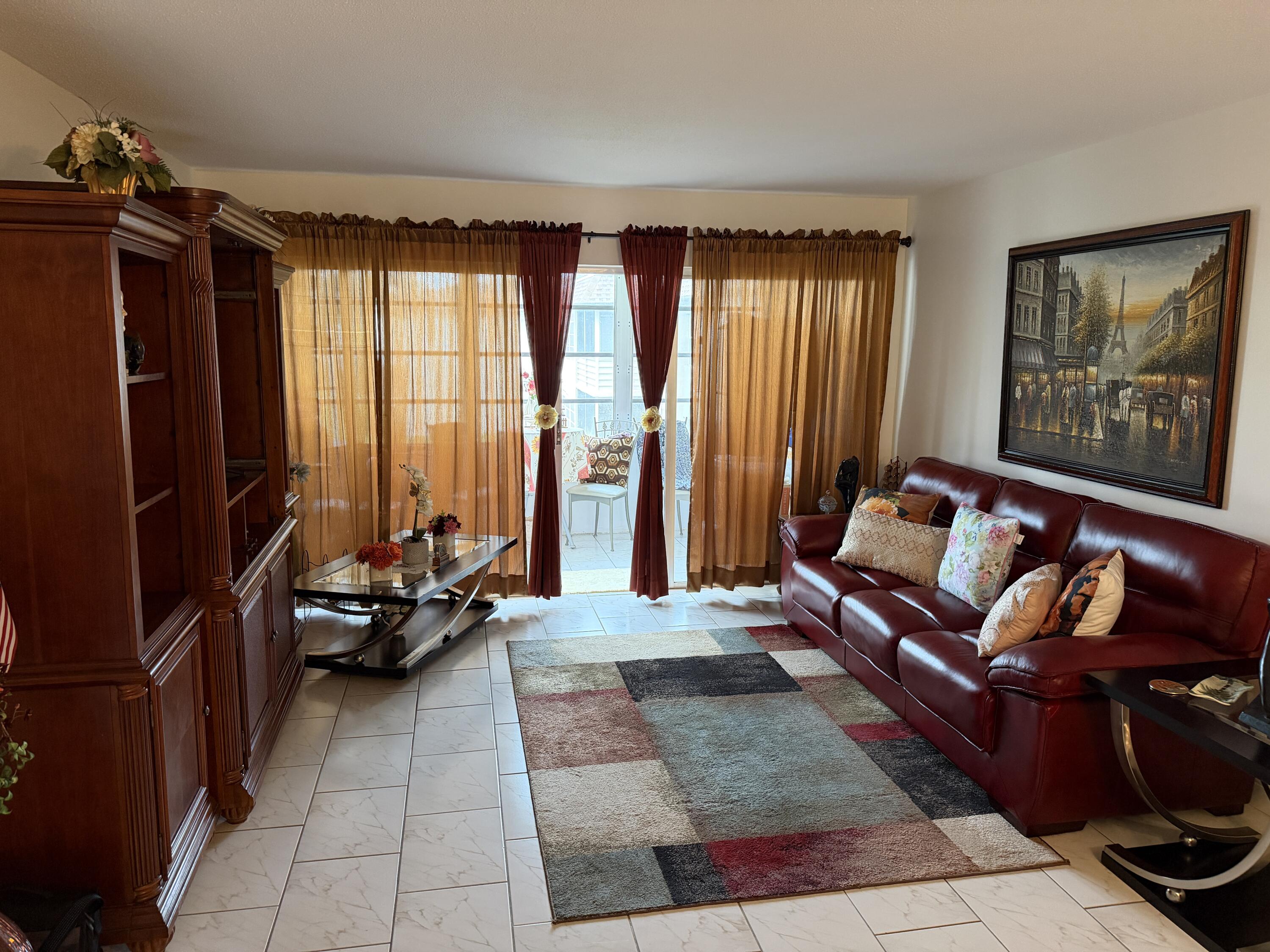 506 Davis Road, Unit 6 Palm Springs, FL 33461 - Photo 16 of 61 a living room with furniture and large windows