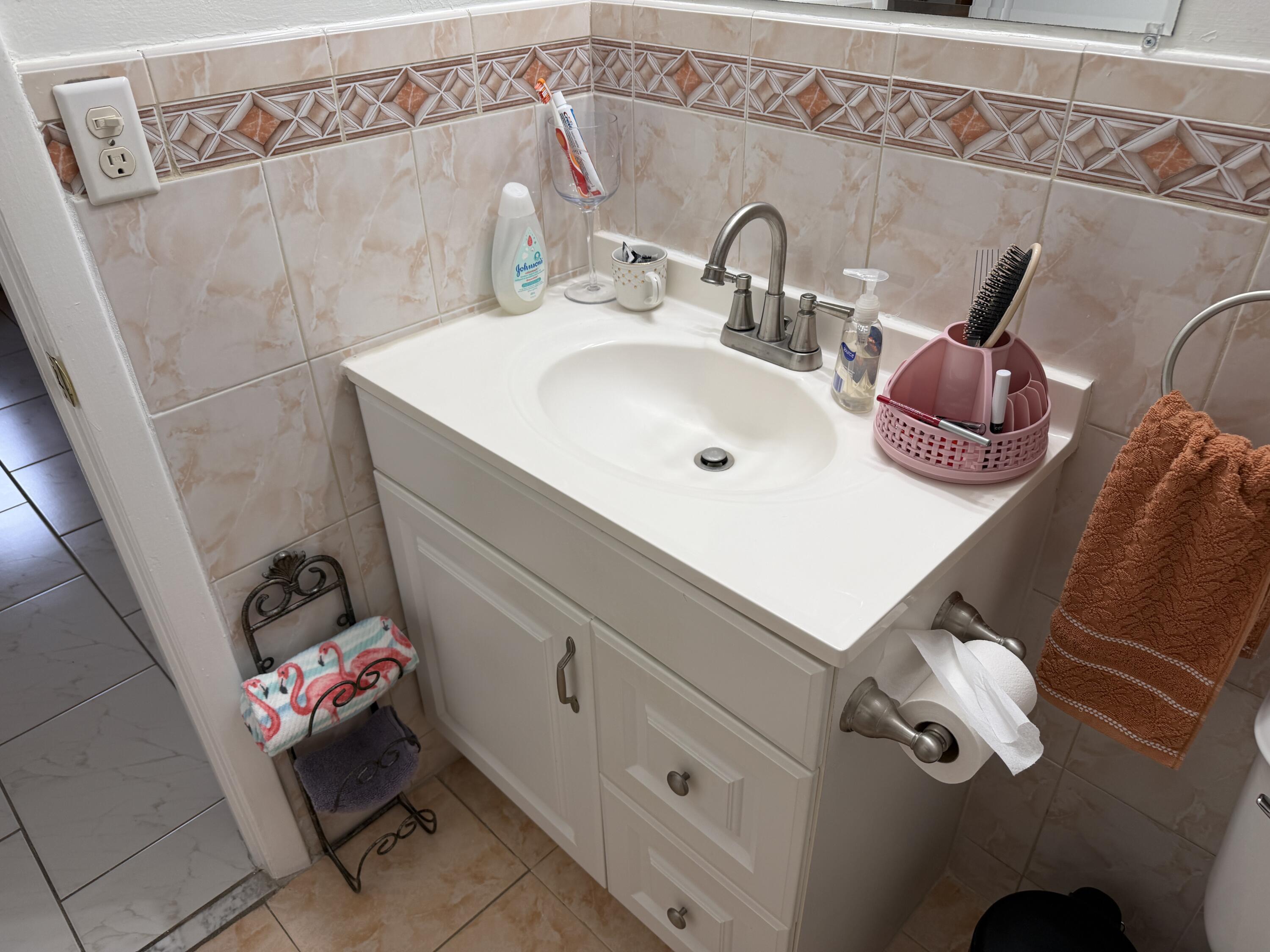 506 Davis Road, Unit 6 Palm Springs, FL 33461 - Photo 28 of 61 a bathroom with a sink and mirror