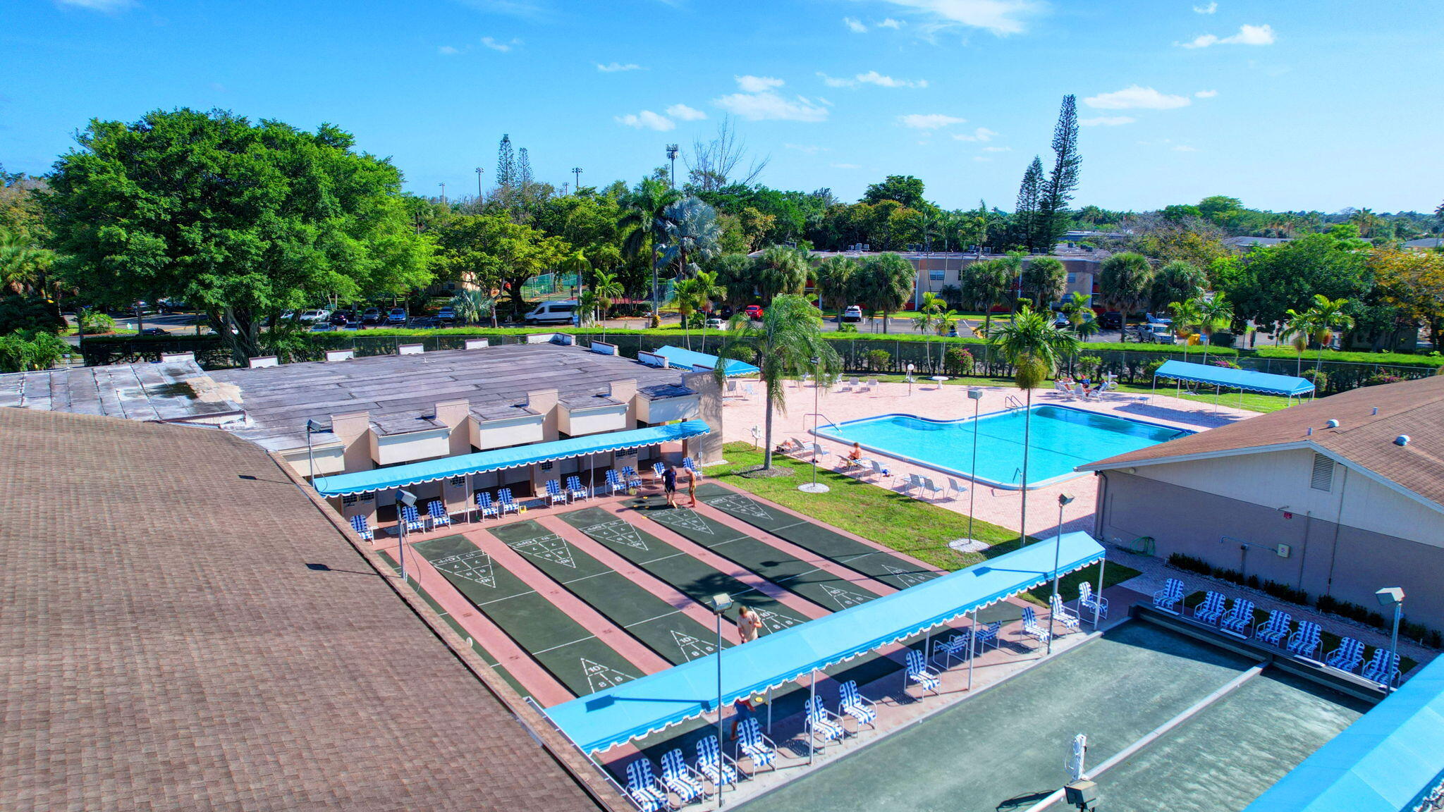 506 Davis Road, Unit 6 Palm Springs, FL 33461 - Photo 55 of 61 a view of a tennis ground with large trees
