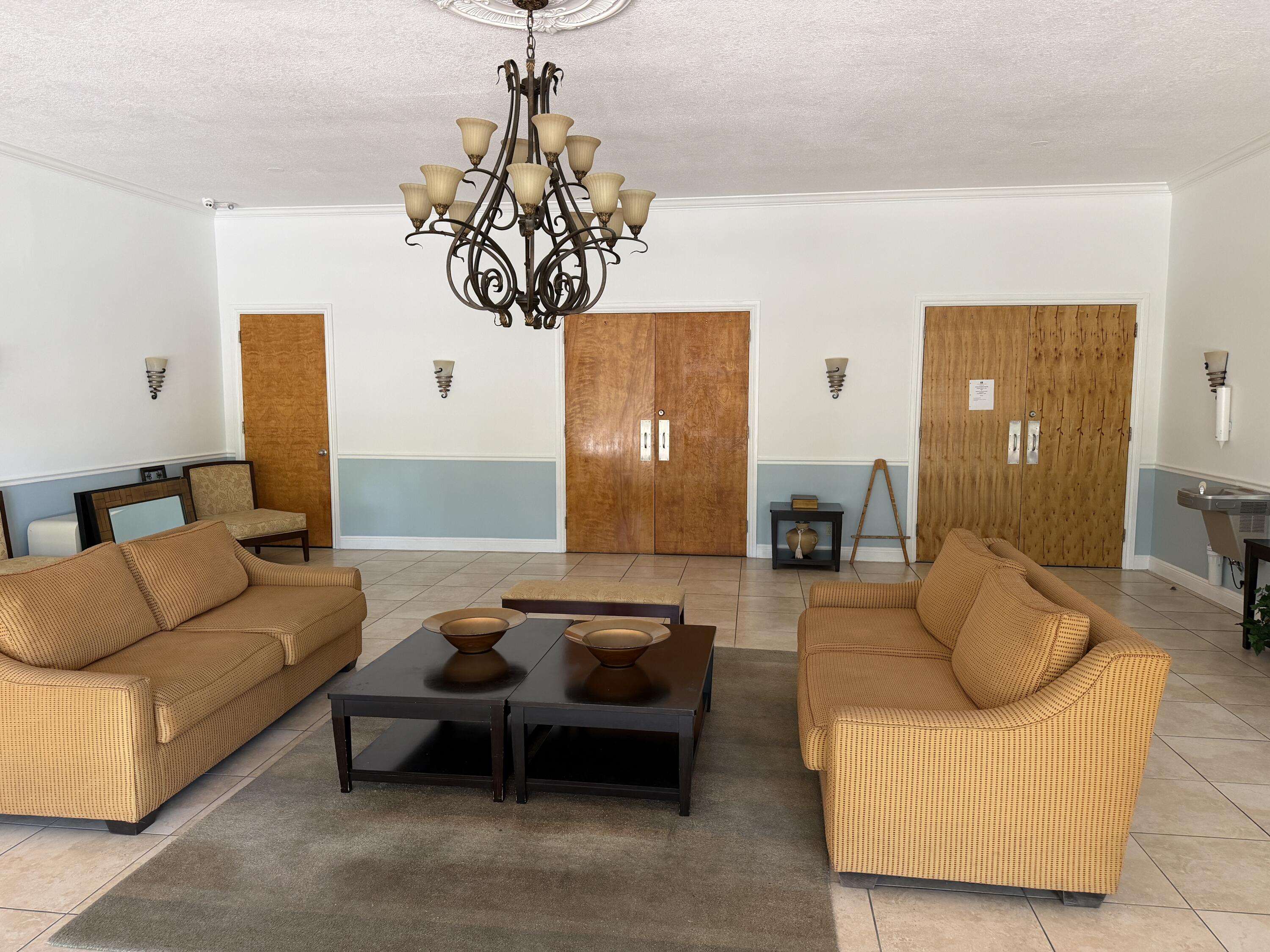 506 Davis Road, Unit 6 Palm Springs, FL 33461 - Photo 60 of 61 a living room with furniture and a chandelier