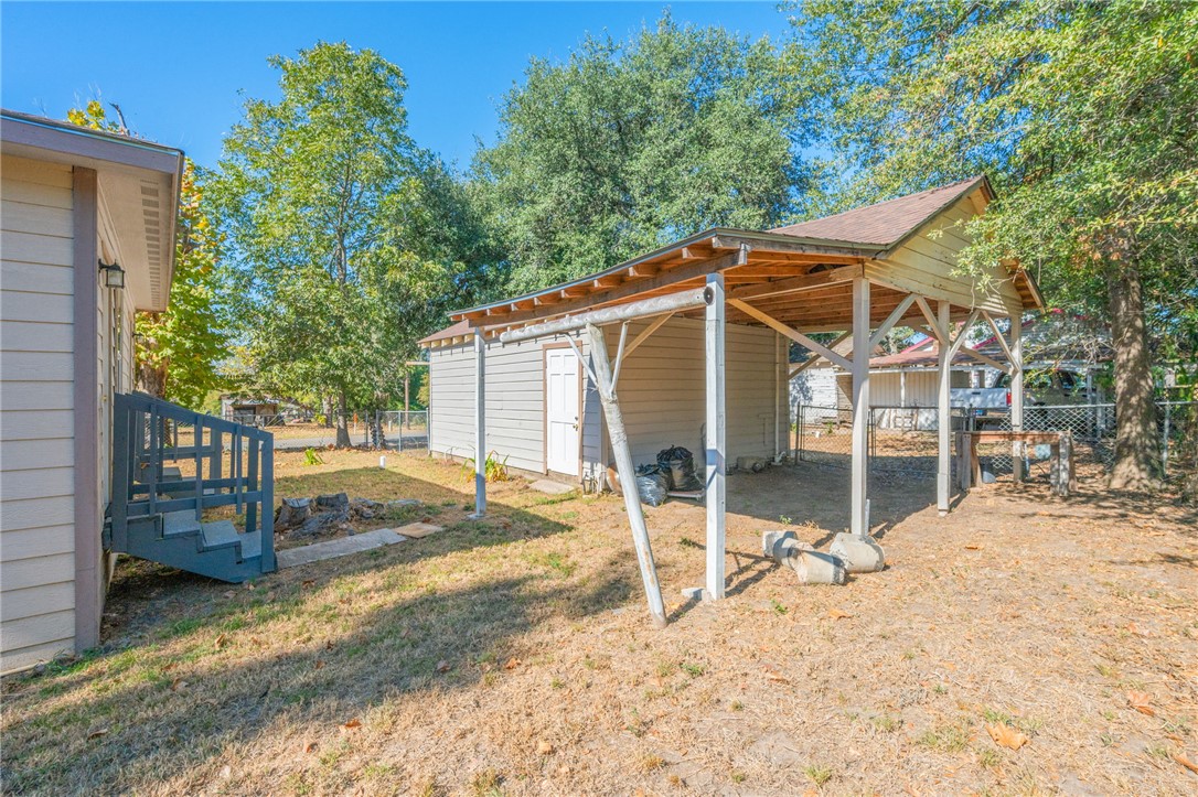 401 East 3rd Street Hearne, TX 77859 - Photo 20 of 24 a view of a wooden house with a yard