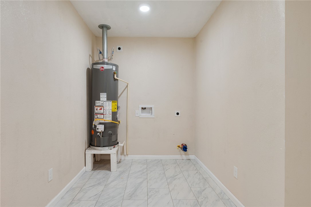 401 East 3rd Street Hearne, TX 77859 - Photo 9 of 24 an empty room with wooden floor and windows