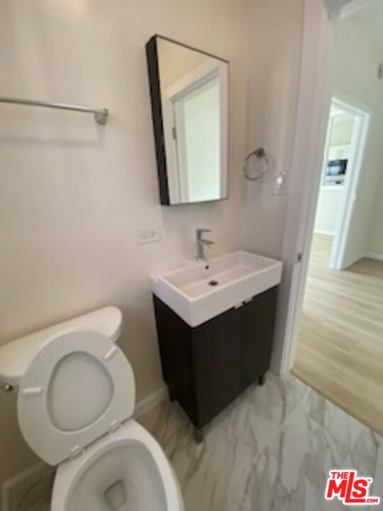814 South Hobart Boulevard, Unit 410 Los Angeles, CA 90005 - Photo 15 of 22 a bathroom with a sink vanity mirror and toilet