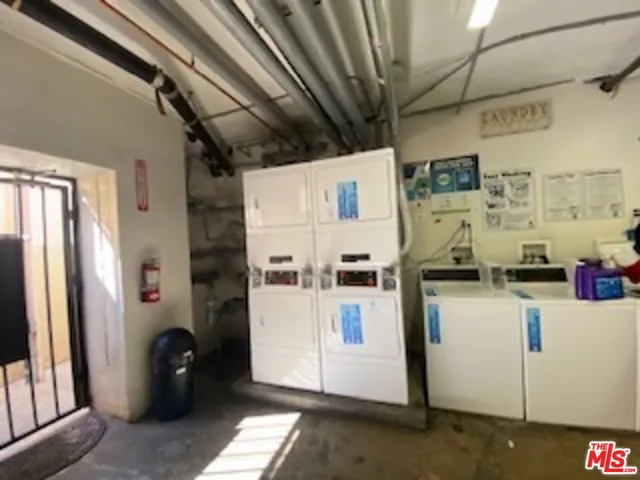 a kitchen with a refrigerator and white cabinets