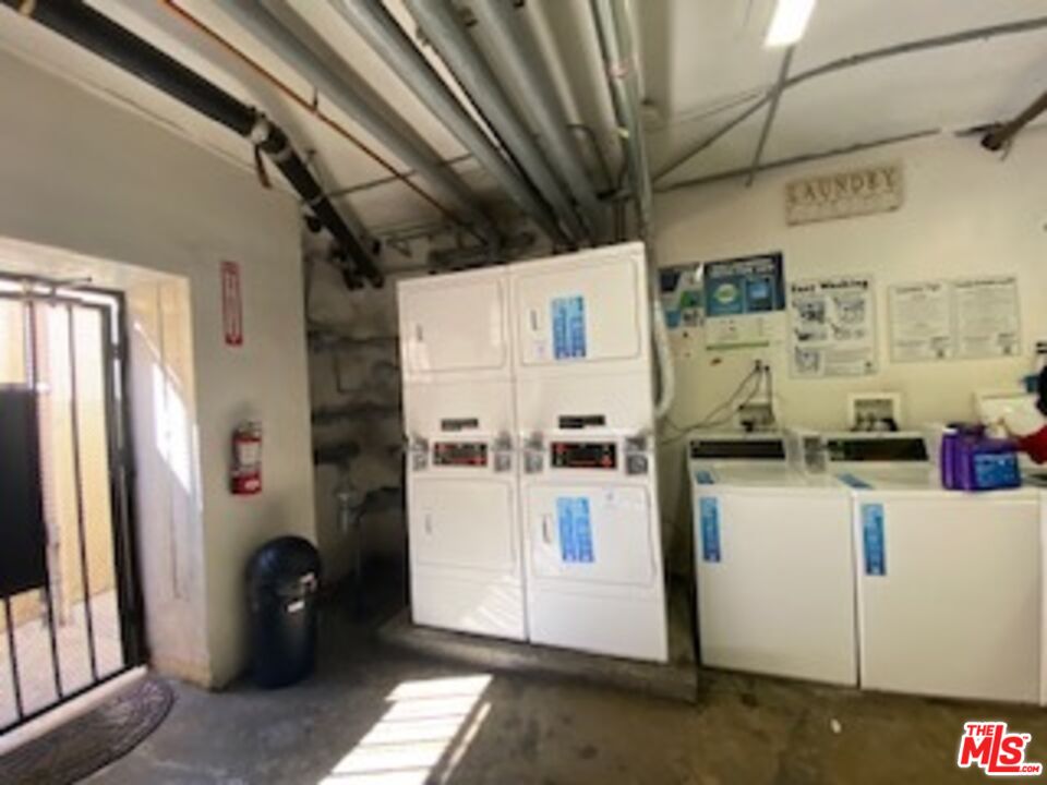 814 South Hobart Boulevard, Unit 410 Los Angeles, CA 90005 - Photo 20 of 22 a kitchen with a refrigerator and white cabinets
