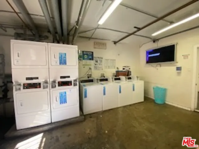 a view of a storage & utility room with a microwave