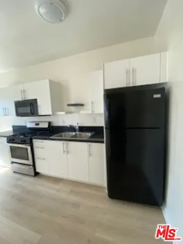a kitchen with a refrigerator and a stove