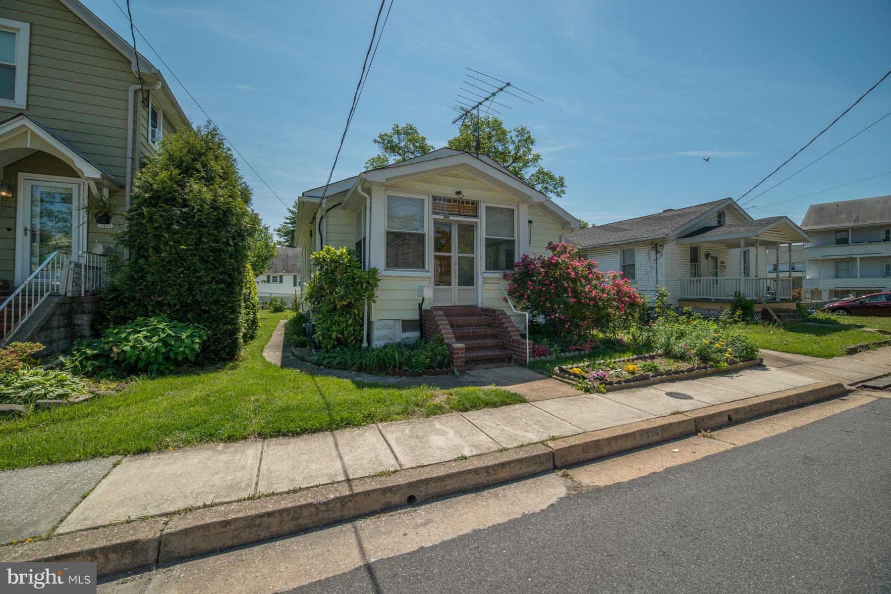 5415 Highview Road Baltimore, MD 21227 - Photo 22 of 25 a front view of a house with a yard and potted plants