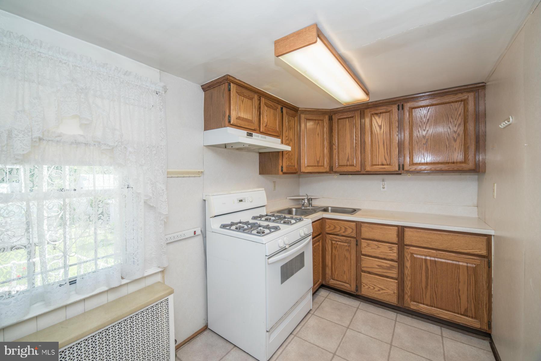 5415 Highview Road Baltimore, MD 21227 - Photo 6 of 25 a kitchen with cabinets appliances and a counter top space
