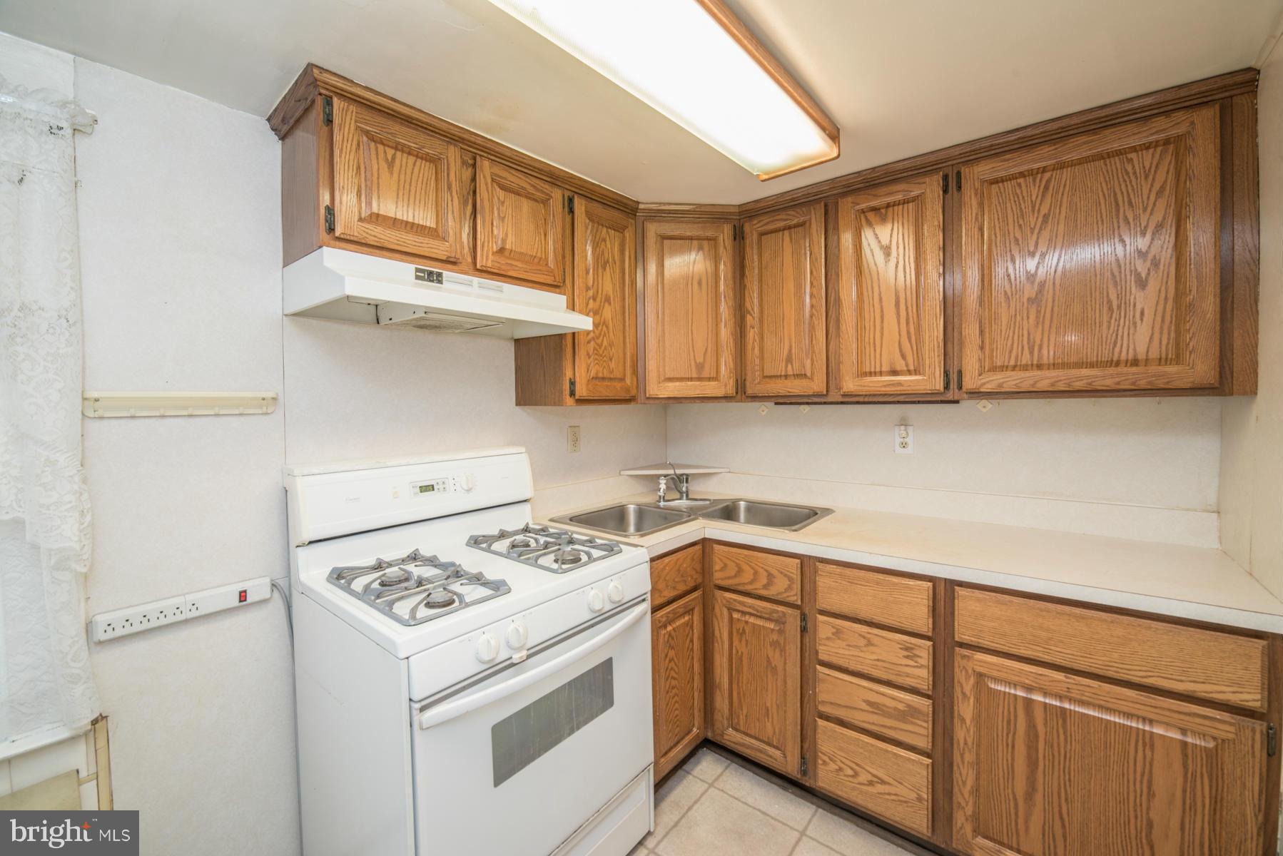 5415 Highview Road Baltimore, MD 21227 - Photo 7 of 25 a kitchen with stainless steel appliances granite countertop a sink stove and cabinets