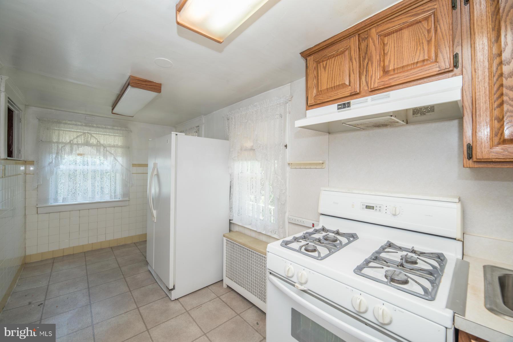 5415 Highview Road Baltimore, MD 21227 - Photo 8 of 25 a kitchen with stainless steel appliances granite countertop a refrigerator and a stove