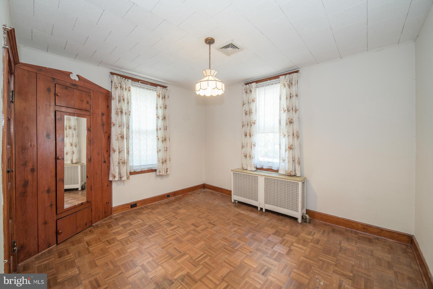 5415 Highview Road Baltimore, MD 21227 - Photo 10 of 25 wooden floor and window in an empty room