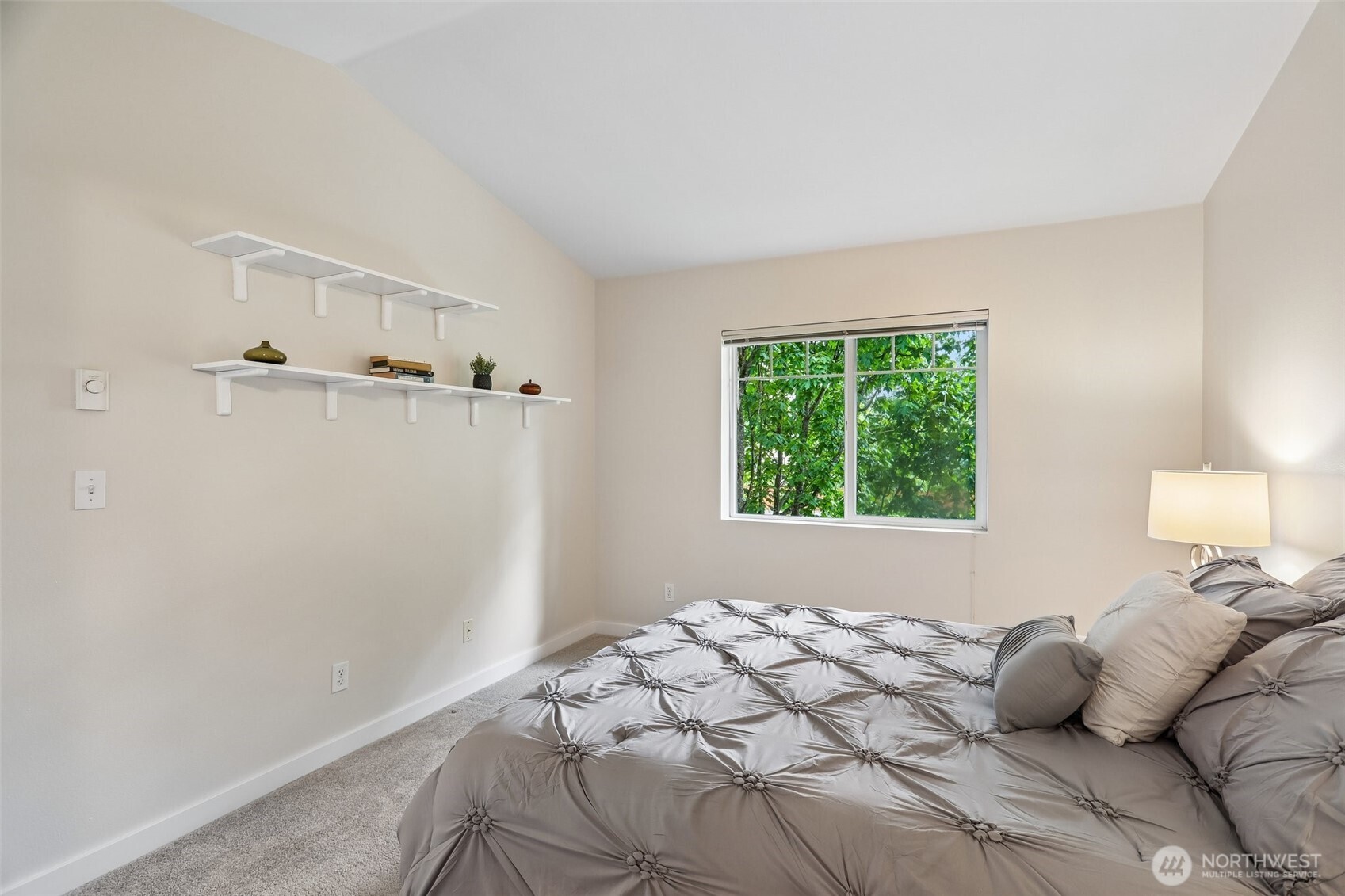 18930 Bothell Everett Highway, Unit E301 Bothell, WA 98012 - Photo 14 of 28 a bedroom with a bed and a window