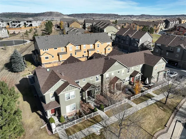 an aerial view of a house with a mountain