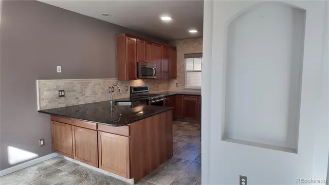 a view of a house with a wooden fence