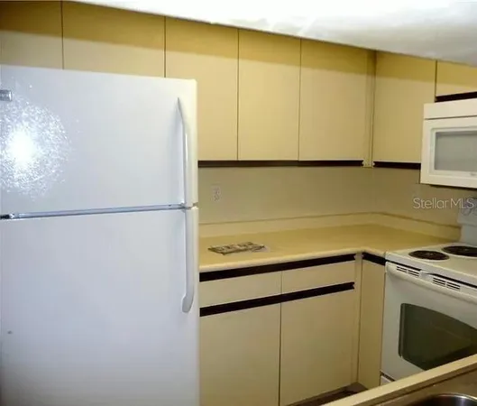 a kitchen with a refrigerator and a microwave