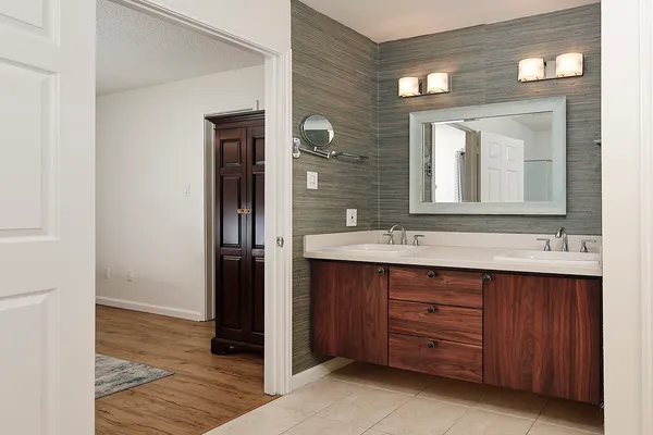 a bathroom with a double vanity sink and a mirror