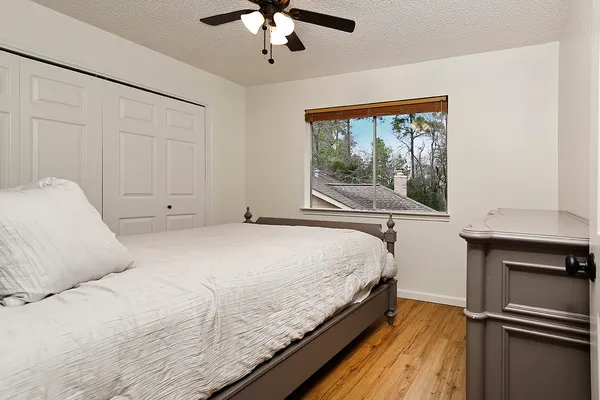 a bedroom with a large bed and a chandelier