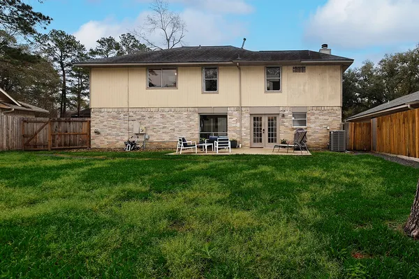 a view of a house with a yard and sitting area