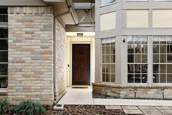 a view of a brick house with a window and wooden floor