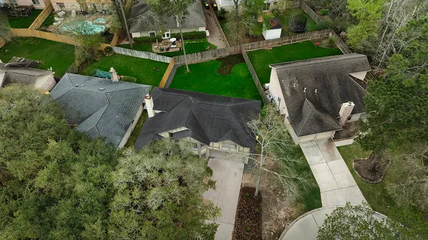 an aerial view of a house with a yard