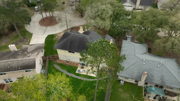 an aerial view of a house with yard swimming pool and outdoor seating