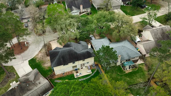 an aerial view of a house with yard