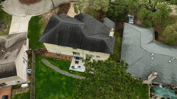 an aerial view of a house with a yard