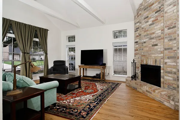 a living room with furniture wooden floor and a flat screen tv