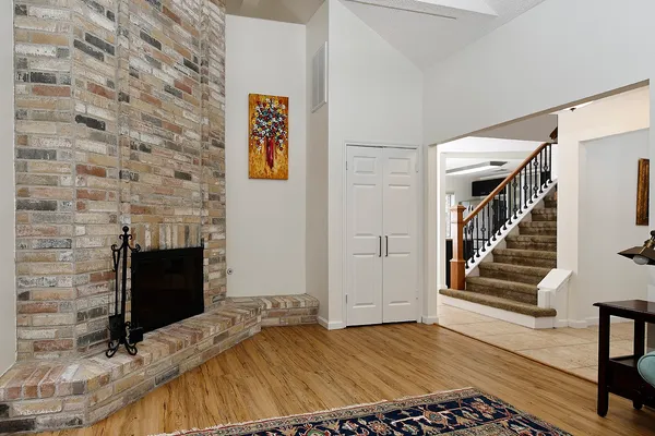 a view of bedroom with wooden floor and fireplace