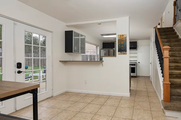 a view of a livingroom with furniture and staircase