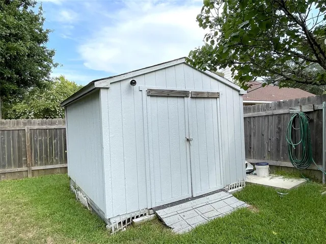 a view of backyard with tub and trees