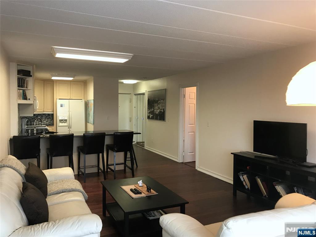 5 Linden Street, Unit 3C Hackensack, NJ 07601 - Photo 11 of 29 a living room with furniture a flat screen tv and kitchen view