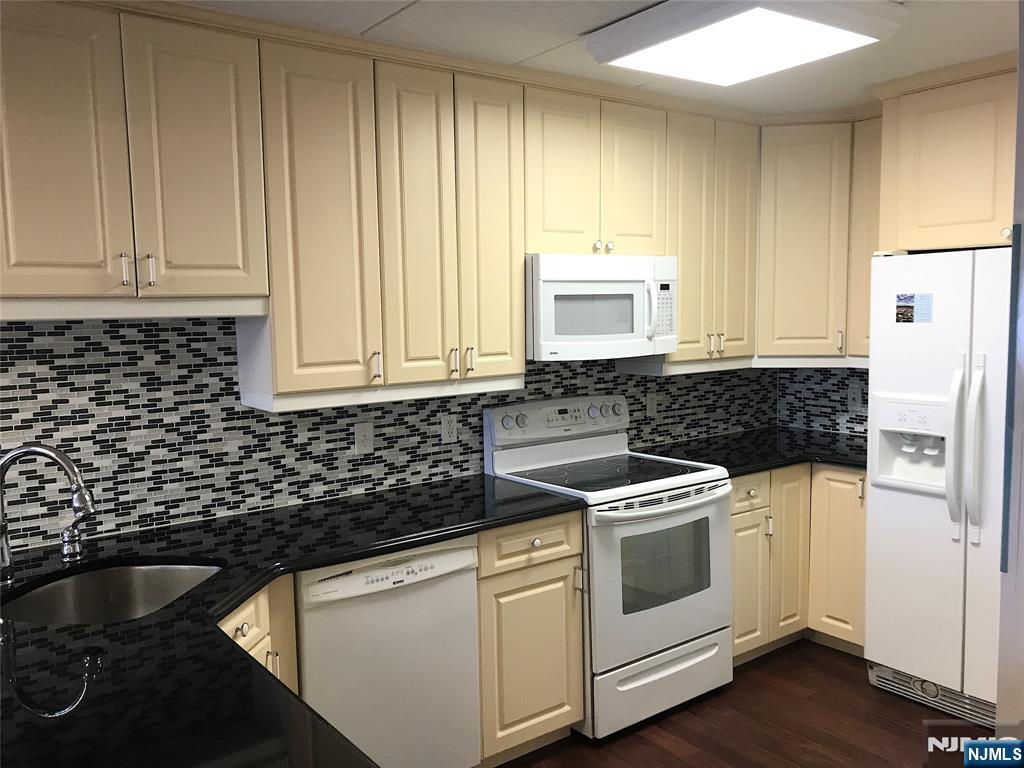 5 Linden Street, Unit 3C Hackensack, NJ 07601 - Photo 14 of 29 a kitchen with appliances a sink and cabinets