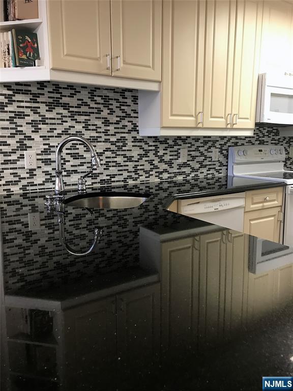 5 Linden Street, Unit 3C Hackensack, NJ 07601 - Photo 15 of 29 a kitchen with a sink a stove and cabinets