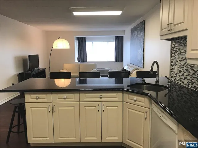 a sink with granite countertop a sink and cabinets