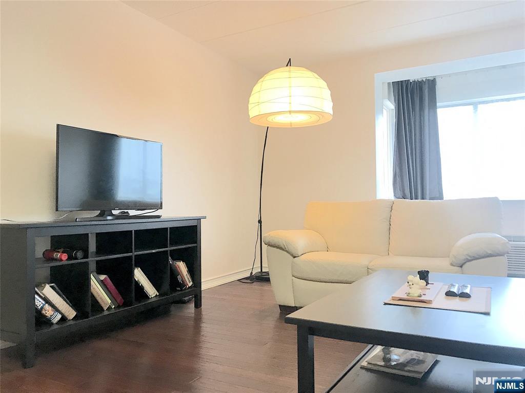 5 Linden Street, Unit 3C Hackensack, NJ 07601 - Photo 17 of 29 a living room with furniture and a flat screen tv