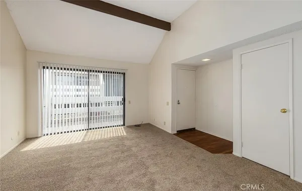a kitchen with a refrigerator and white cabinets